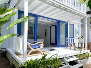 a porch with a rocking chair on a house at Kenzo hut3 mesari in Seminyak