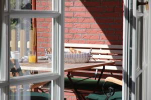 a picnic table with a basket of bread on it at Romantik-Residenz Landhaus Greetsiel - B in Krummhörn