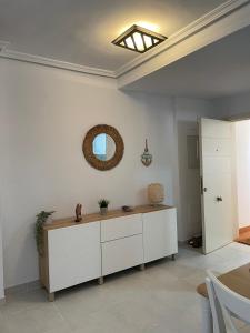 a living room with a table and a mirror at Urbanización Altos de Nuevo Vera in Vera
