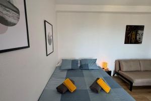 a large bed in a room with a couch at Sea views from the bed Design studio in Torrox +8 photos