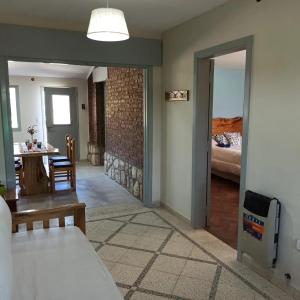 a living room with a dining table and a bedroom at La Estrella 2 in Huerta Grande +12 photos
