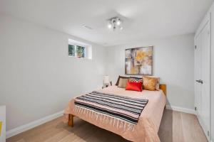 a bedroom with a bed with a blanket on it at New 2 bedroom basement apartment in Guelph