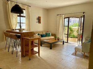 a living room with a couch and a table at Maison de village in Fontvieille