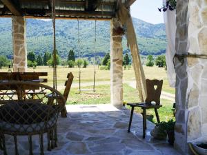 a patio with a table and chairs and a view at Chalet with Barbecue in Brezna in Pluzine