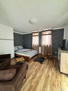 a living room with a couch and a bed at Northern Panorama in Jílové