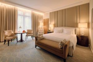 a hotel room with a bed and a table and chairs at Corinthia London in London +123 photos