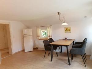 a kitchen and dining room with a table and chairs at Ferienwohnungen Dornröschen in Weißensberg