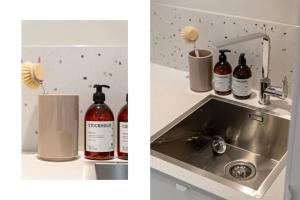 un bancone della cucina con bottiglie di alcol e un lavandino di New and Urban Apartment, centrally located close to nature a Haugesund Altre 7 foto