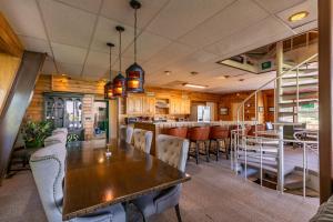 a dining room with a wooden table and chairs at Endless Vistas in Seven Devils