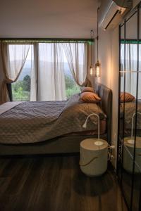 a bedroom with a large bed and a window at Casa Slarku - Luxury Container Houses in Miskolc