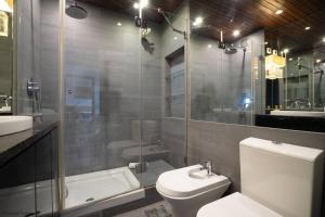 a bathroom with a toilet and a shower and a sink at Atlantic Views in Estoril