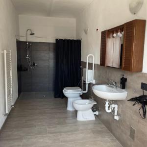 a bathroom with a toilet and a sink at La Tana di Momo in Vezza d'Alba +8 photos