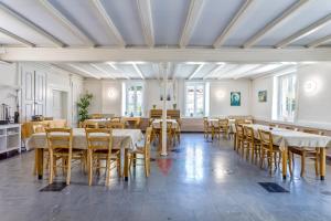 a large dining room with tables and chairs at Gîte de groupe Val dOrey in Ruffieu +22 photos