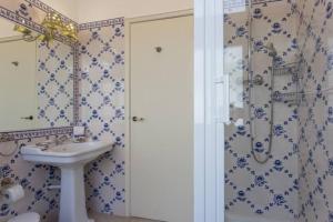 a bathroom with a sink and a shower at Carcavelos - Holiday Beach Apartment in Carcavelos +27 photos