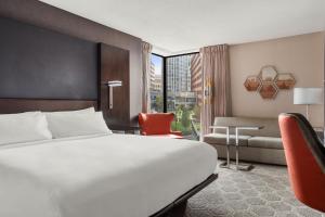 a hotel room with a bed and a chair at Boston Marriott Cambridge in Cambridge +82 photos