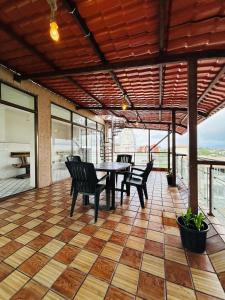 a patio with a table and chairs on a floor at PP with rooftop pool and bathtub in Lonavala