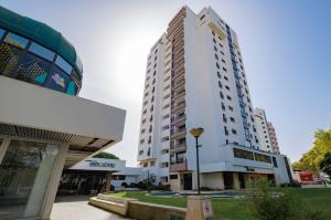 a tall white building in front of a building at Cascais Panoramic Apartment in Cascais