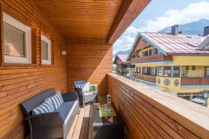 a balcony with two chairs and a table and a house at Apartments am alten Rathaus in Oberstdorf