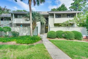 a house with a palm tree in the yard at Mount Pleasant Condo - Near Charleston and Beaches! in Charleston