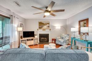 a living room with a couch and a ceiling fan at Mount Pleasant Condo - Near Charleston and Beaches! in Charleston