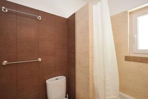 a bathroom with a toilet and a shower curtain at Central Oasis Apartment in Cascais +25 photos