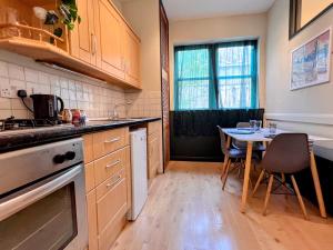 a kitchen with a table and a dining room at INNit Bloom - Triple Studio in Brighton & Hove