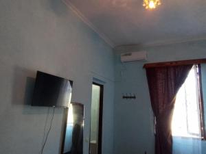 TV o dispositivi per l'intrattenimento presso Guest House Buche 219