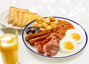 a plate of breakfast food with eggs bacon beans and toast at Days Inn Sutton Scotney North in Sutton Scotney