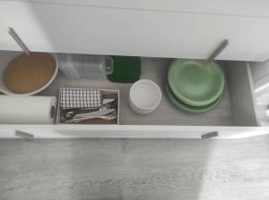 a cupboard with bowls and plates in a kitchen at Habitación Namasté in Playa Blanca +15 photos