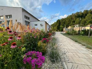 a garden with flowers in front of a building at Vegas Hriňová Penzión in Hriňová