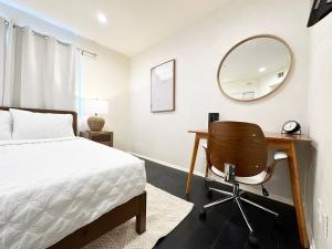 a bedroom with a bed and a desk and a mirror at Bohemian Dream- 2BR, Retreat Near Hollywood -BR6 in Los Angeles