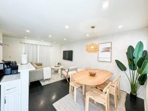 a kitchen and living room with a wooden table and chairs at Bohemian Dream- 2BR, Retreat Near Hollywood -BR6 in Los Angeles