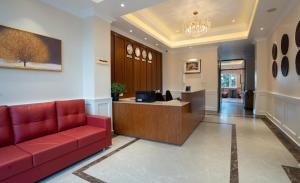 an office with a red couch in a lobby at Preisha Hotel and Resorts in Gangtok