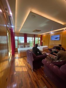 a group of people sitting in a living room at North Palace Khaplu in Khaplu