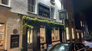 a building with a car parked in front of it at St Ives in Neath