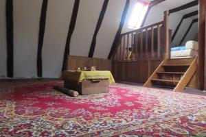 a room with a carpet on the floor and a staircase at grange cavanet in Goulles