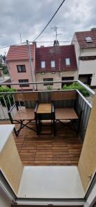 a balcony with a table and benches on a building at Apartment Mitis in Hodonín
