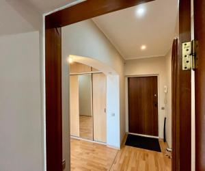 an empty room with a hallway with a door at sairan comfort in Almaty