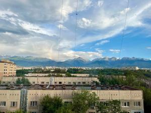 a view of a city with mountains in the background at sairan comfort in Almaty
