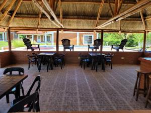 a dining area with tables and chairs in a building at Nuova Costa Cabañas in Los Molles
