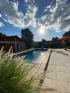 a swimming pool in front of a house at Nuova Costa Cabañas in Los Molles