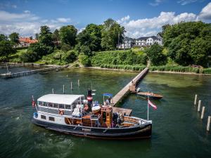 a boat is docked at a dock in the water at Stella Maris in Svendborg