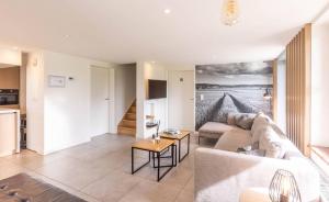 a living room with a couch and a table at KoppenHerberg in Oudenaarde