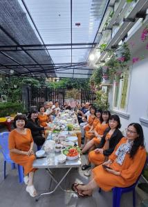 a group of people sitting at a long table at MIA Villa Đà Lạt in Khu Chi Lăng