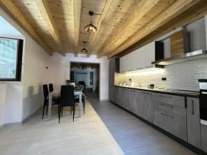 a kitchen with a table and a dining room at La dimora nelle Rue in Civitella Roveto