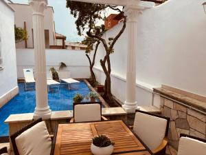 a patio with a table and chairs and a pool at Mare di Roma 2 in Lido di Ostia