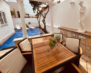 a table and chairs on a patio with a statue at Mare di Roma 2 in Lido di Ostia