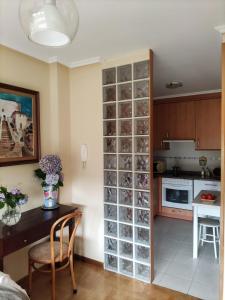 a kitchen with a large glass wine cellar at Apartamento Miravalles in Muros de Nalón