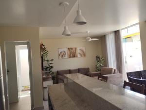 a kitchen and living room with a table and chairs at Casa Jacuípe in Camaçari