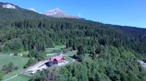 an aerial view of a house in the middle of a mountain at Agriturismo Ai Castioni in Molveno